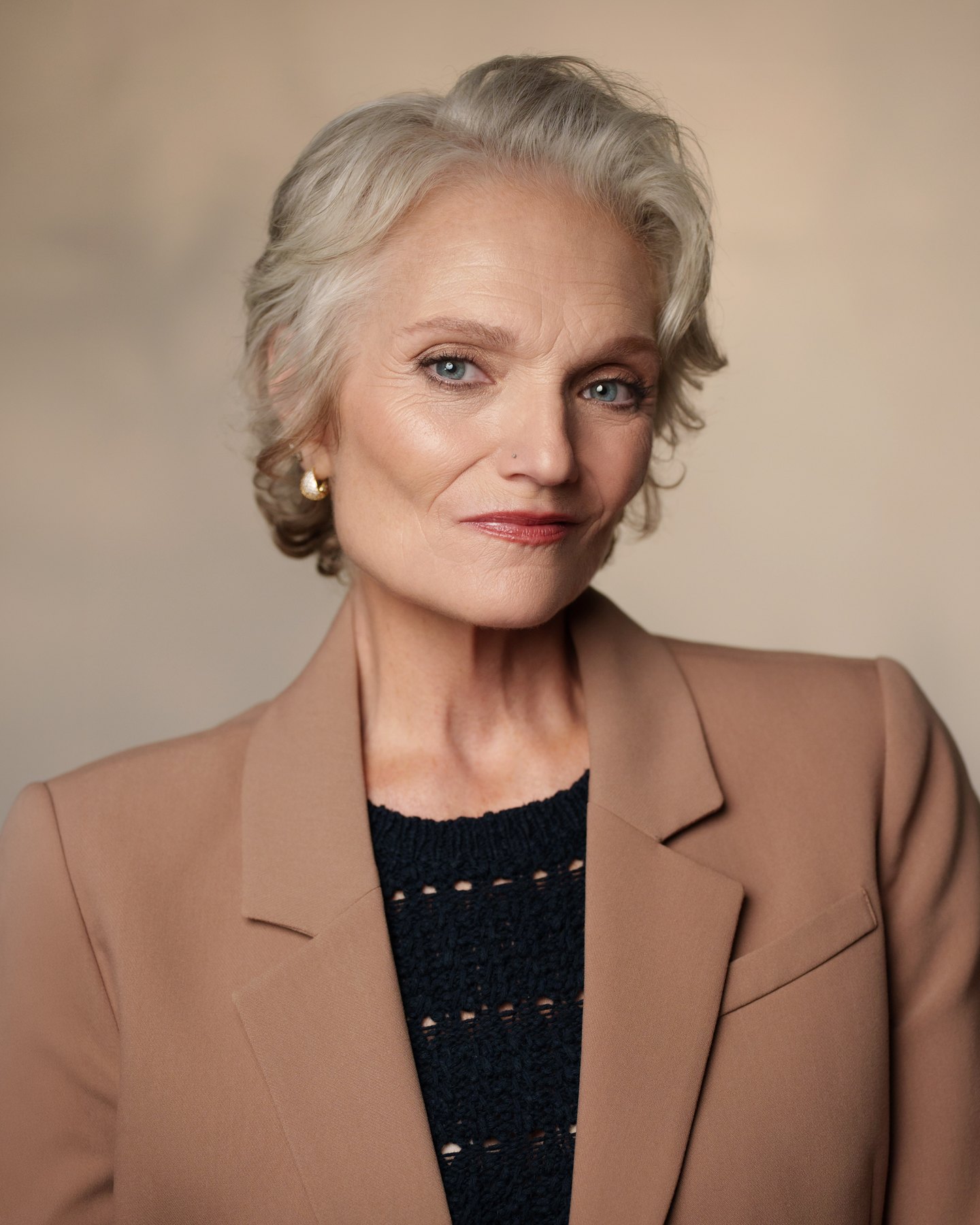 Catherine Handy NYC commercial model, studio headshot in camel blazer, photographer Kat Hennessey
